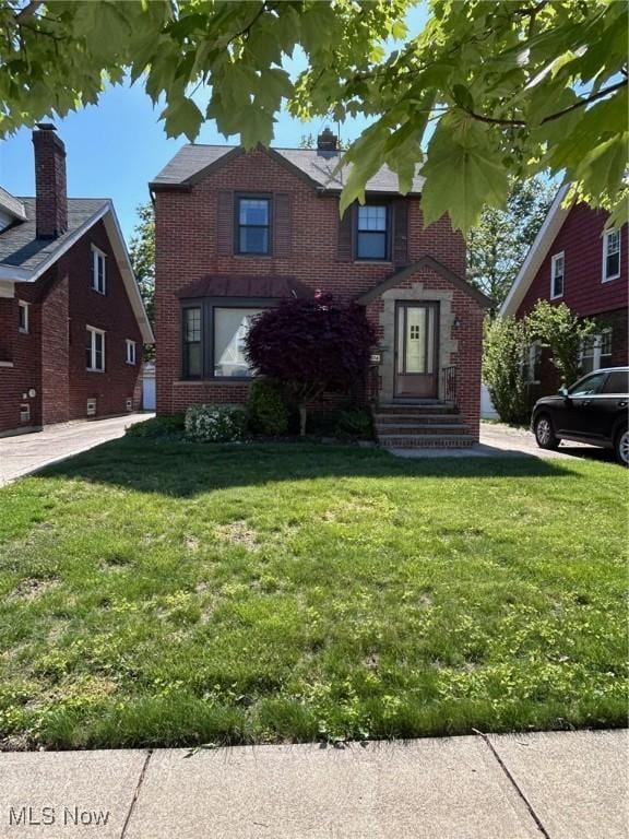 104 Sunnycliff Dr, Euclid, OH 44123 - view of front facade with brick siding and a front yard