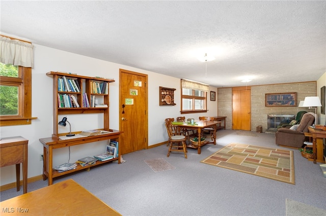 125 Beech St, Doylestown, OH 44230 - dining room featuring a fireplace, carpet floors, a textured ceiling, and baseboards