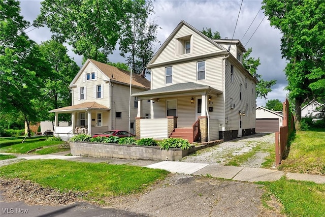 916 Kling St, Akron, OH 44311 - american foursquare style home featuring a porch, an outbuilding, and a front yard