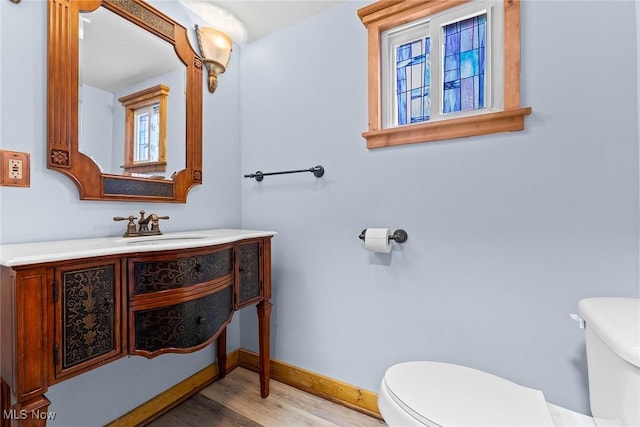 916 Kling St, Akron, OH 44311 - bathroom with toilet, wood finished floors, vanity, and baseboards
