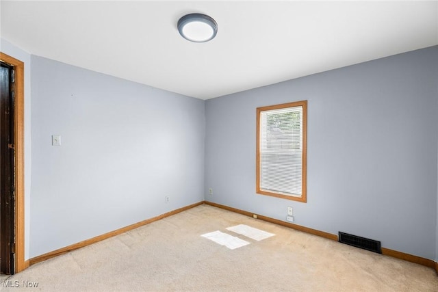 916 Kling St, Akron, OH 44311 - spare room with baseboards and light colored carpet