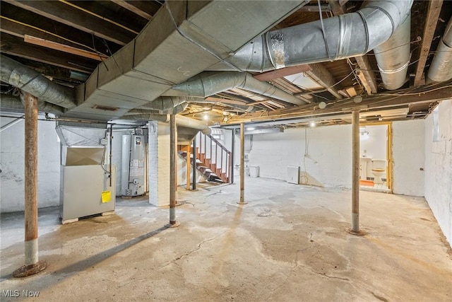 916 Kling St, Akron, OH 44311 - unfinished basement with water heater, heating unit, and stairway