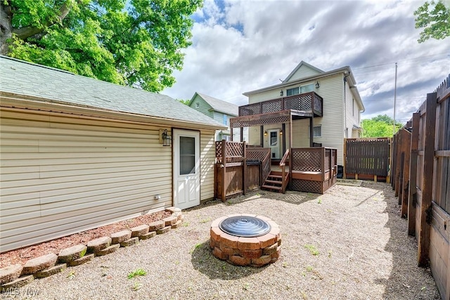 916 Kling St, Akron, OH 44311 - back of house with a fire pit, a fenced backyard, a deck, a balcony, and a shingled roof