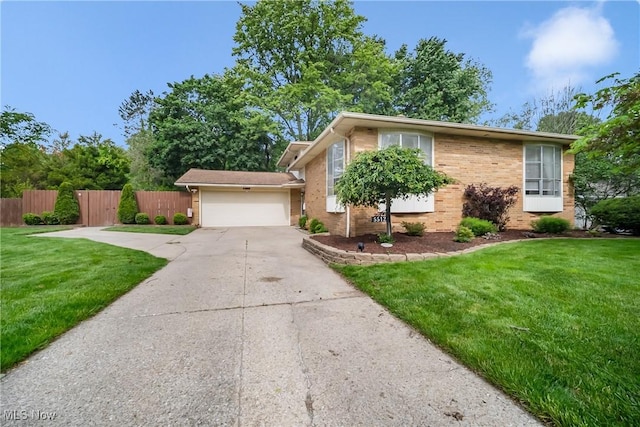 5512 Berkshire Dr, North Olmsted, OH 44070 - view of front of house featuring a garage, brick siding, and concrete driveway