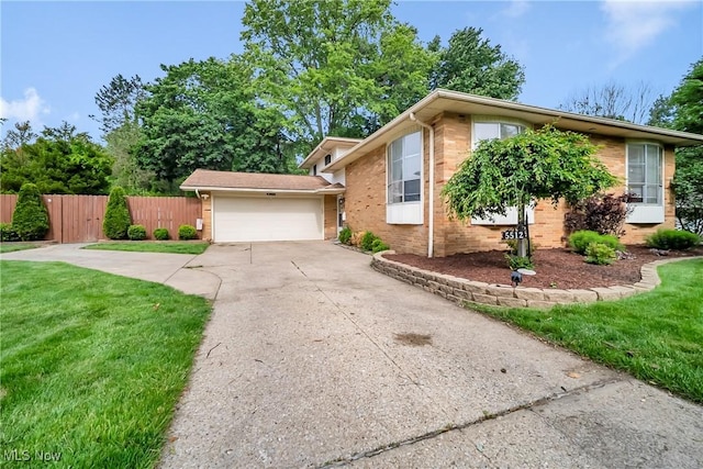 5512 Berkshire Dr, North Olmsted, OH 44070 - view of front facade with brick siding, an attached garage, and driveway
