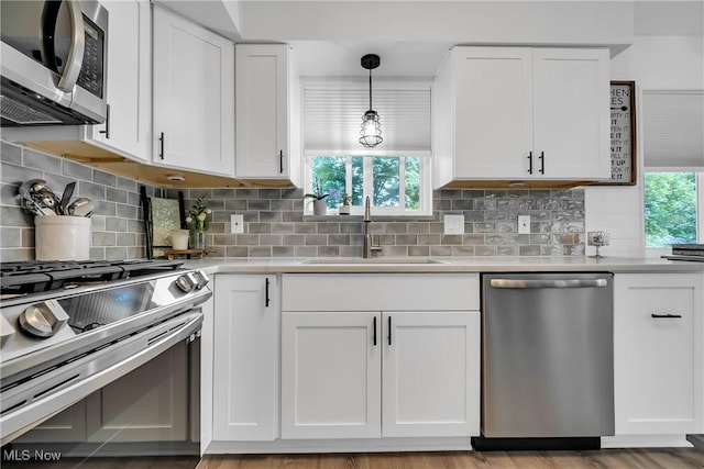 5512 Berkshire Dr, North Olmsted, OH 44070 - kitchen with appliances with stainless steel finishes, a sink, light countertops, and white cabinetry