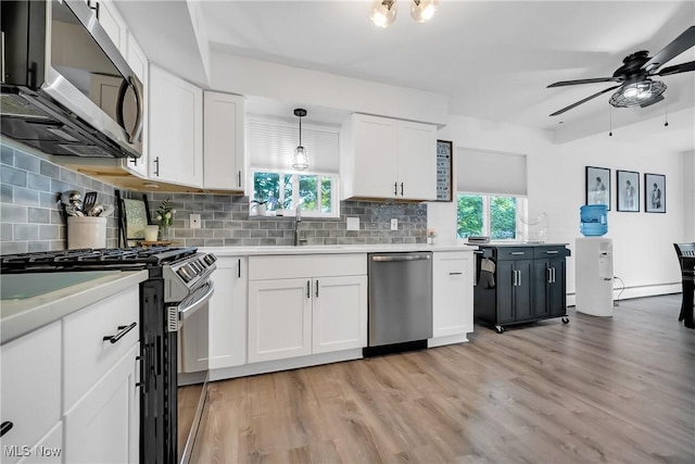 5512 Berkshire Dr, North Olmsted, OH 44070 - kitchen featuring stainless steel appliances, a ceiling fan, a sink, light countertops, and light wood-style floors