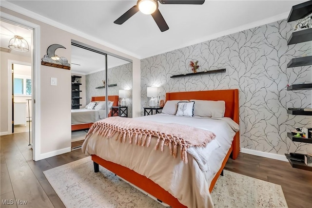 5512 Berkshire Dr, North Olmsted, OH 44070 - bedroom with wallpapered walls, an accent wall, baseboards, and wood finished floors