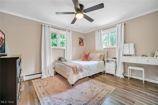 5512 Berkshire Dr, North Olmsted, OH 44070 - bedroom with baseboard heating, multiple windows, wood finished floors, and crown molding