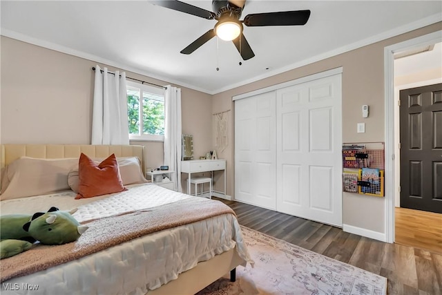 5512 Berkshire Dr, North Olmsted, OH 44070 - bedroom featuring crown molding, dark wood-type flooring, baseboards, a closet, and ceiling fan