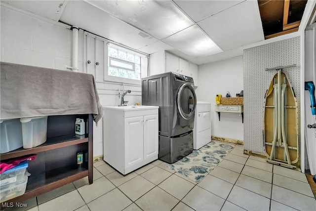 5512 Berkshire Dr, North Olmsted, OH 44070 - laundry room featuring cabinet space and light tile patterned floors