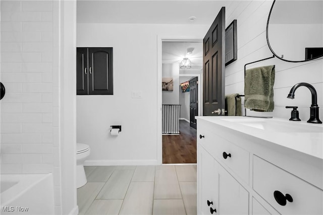 5512 Berkshire Dr, North Olmsted, OH 44070 - bathroom with vanity, toilet, baseboards, and tile patterned flooring