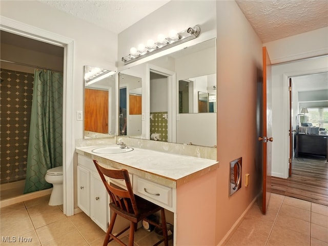 4300 Wade Ave, Ashtabula, OH 44004 - bathroom featuring tile patterned floors, a textured ceiling, vanity, and a tile shower