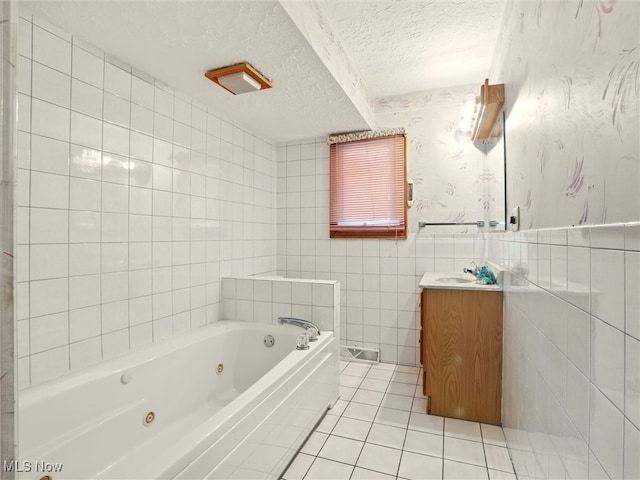 4300 Wade Ave, Ashtabula, OH 44004 - bathroom with vanity, a whirlpool tub, a textured ceiling, wallpapered walls, and tile patterned flooring