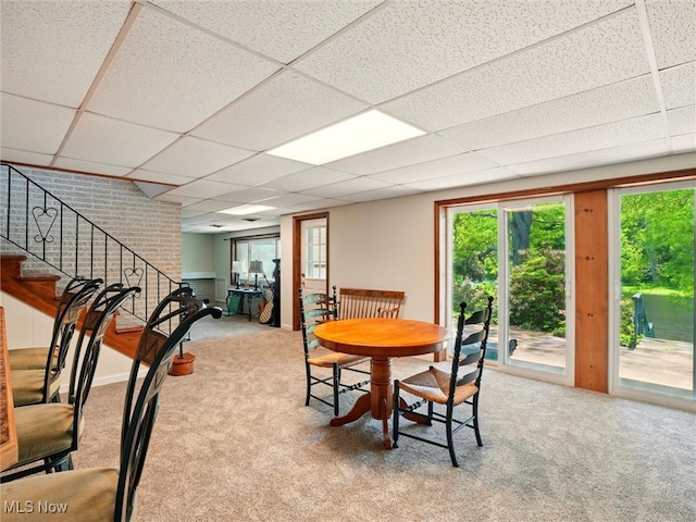 4300 Wade Ave, Ashtabula, OH 44004 - dining area with carpet flooring, a paneled ceiling, healthy amount of natural light, and stairway