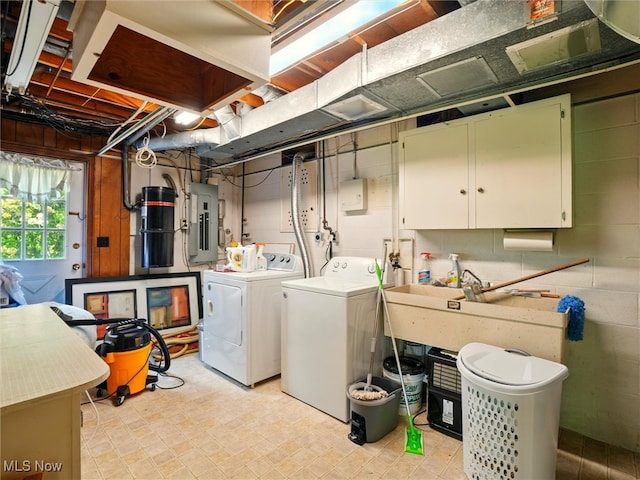 4300 Wade Ave, Ashtabula, OH 44004 - washroom featuring washing machine and clothes dryer, electric panel, cabinet space, and light floors