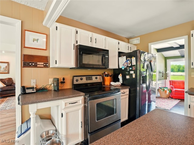 4300 Wade Ave, Ashtabula, OH 44004 - kitchen featuring stainless steel appliances, dark countertops, wood finished floors, and white cabinetry