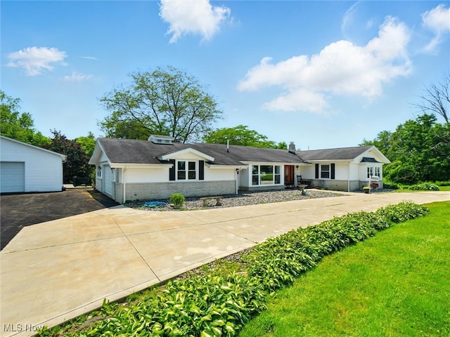 4300 Wade Ave, Ashtabula, OH 44004 - ranch-style home with a detached garage, brick siding, a chimney, driveway, and an outdoor structure