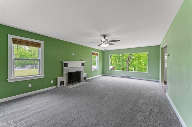 15800 Shilling Rd, Berlin Center, OH 44401 - unfurnished living room featuring carpet, a tile fireplace, a ceiling fan, and baseboards