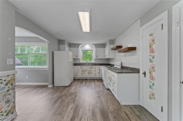 15800 Shilling Rd, Berlin Center, OH 44401 - kitchen with white appliances, dark countertops, a sink, white cabinets, and wood finished floors