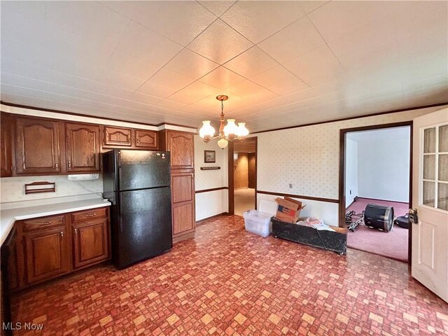 56400 Boyd Ave, Bridgeport, OH 43912 - kitchen with freestanding refrigerator, light countertops, a chandelier, hanging light fixtures, and wallpapered walls