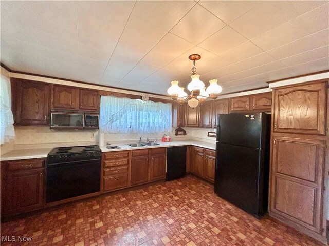 56400 Boyd Ave, Bridgeport, OH 43912 - kitchen with black appliances, a sink, a chandelier, and light countertops