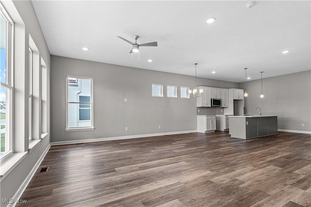 360 Bascule Dr, Lorain, OH 44052 - unfurnished living room featuring dark wood finished floors, recessed lighting, and a ceiling fan