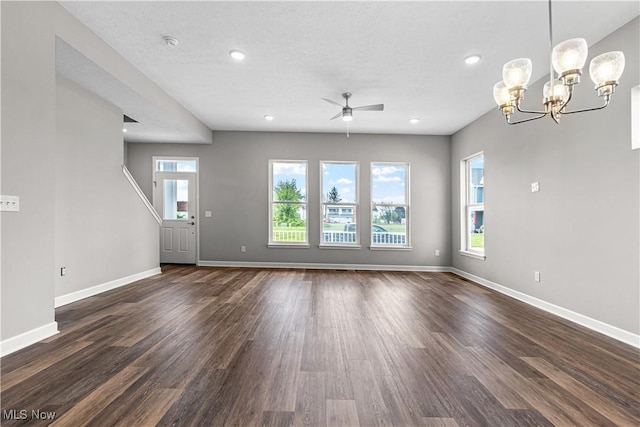 360 Bascule Dr, Lorain, OH 44052 - unfurnished living room with dark wood-style flooring, ceiling fan, a chandelier, and recessed lighting