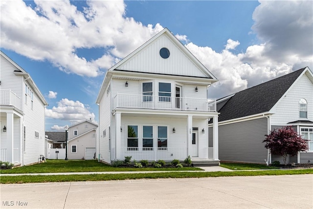 360 Bascule Dr, Lorain, OH 44052 - view of front facade with a balcony, board and batten siding, and a front yard