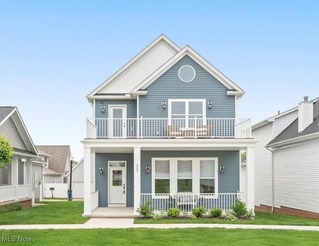 322 Bascule Dr, Lorain, OH 44052 - view of front facade with a balcony, covered porch, and a front yard