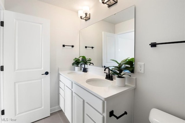 322 Bascule Dr, Lorain, OH 44052 - bathroom with double vanity, toilet, and tile patterned flooring