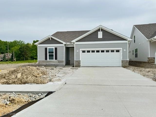 423 Clipper Ct, Avon Lake, OH 44012 - view of front facade with a garage, concrete driveway, and stone siding