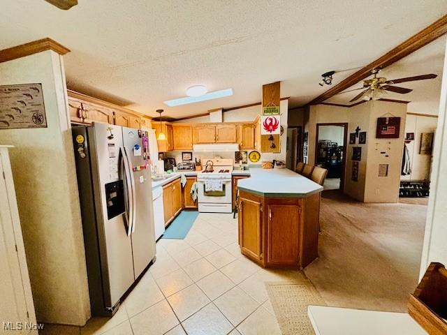 147 Northgate Dr NE, Warren, OH 44484 - kitchen featuring white range oven, stainless steel fridge with ice dispenser, vaulted ceiling, under cabinet range hood, and light countertops