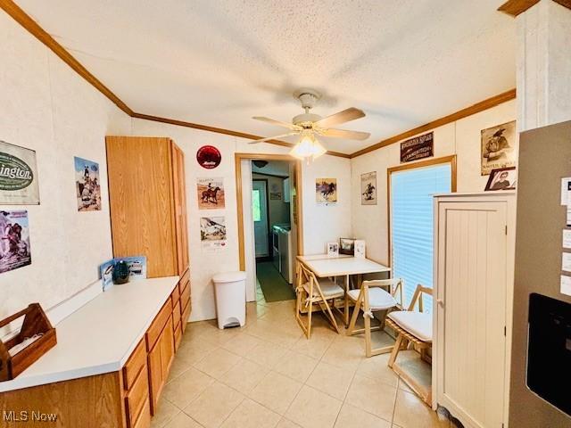 147 Northgate Dr NE, Warren, OH 44484 - dining area with crown molding, ceiling fan, light tile patterned floors, and a textured ceiling