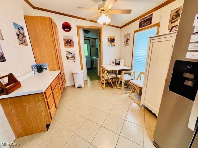 147 Northgate Dr NE, Warren, OH 44484 - dining area with ornamental molding, washing machine and clothes dryer, light tile patterned floors, and ceiling fan