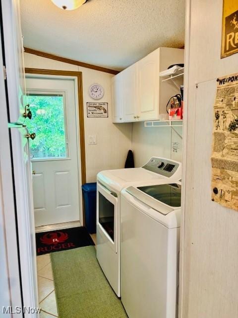 147 Northgate Dr NE, Warren, OH 44484 - laundry area featuring separate washer and dryer, cabinet space, light tile patterned floors, and a textured ceiling