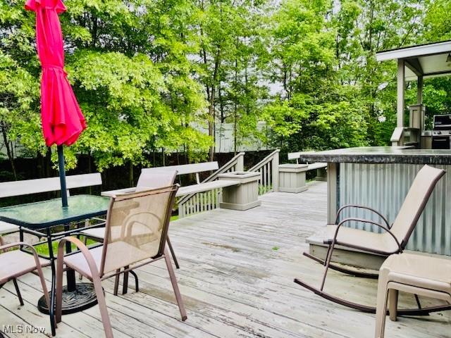 147 Northgate Dr NE, Warren, OH 44484 - deck featuring outdoor dining space and view of scattered trees