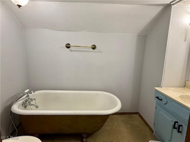 42096 Cadiz Dennison Rd, Cadiz, OH 43907 - full bathroom featuring vanity, a soaking tub, vaulted ceiling, and baseboards