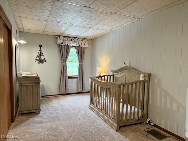 42096 Cadiz Dennison Rd, Cadiz, OH 43907 - bedroom with light carpet, a nursery area, baseboards, and wooden walls