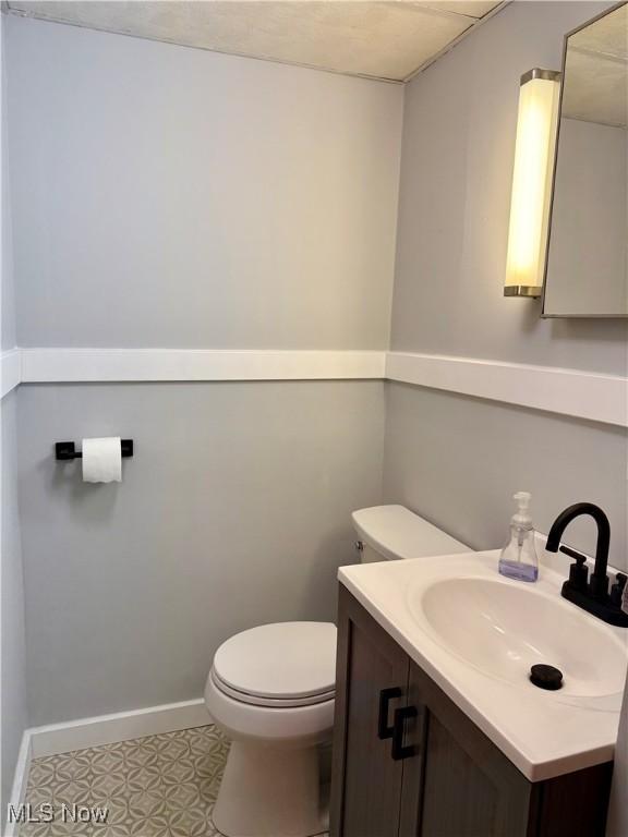 42096 Cadiz Dennison Rd, Cadiz, OH 43907 - bathroom featuring vanity, toilet, baseboards, and tile patterned floors