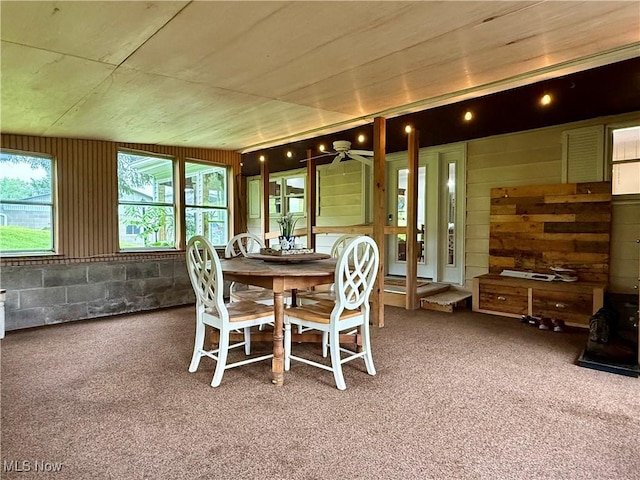 42096 Cadiz Dennison Rd, Cadiz, OH 43907 - carpeted dining area with ceiling fan and wooden walls