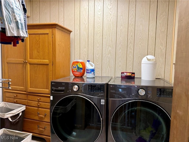 42096 Cadiz Dennison Rd, Cadiz, OH 43907 - laundry area featuring separate washer and dryer, wooden walls, and cabinet space