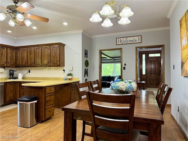 42096 Cadiz Dennison Rd, Cadiz, OH 43907 - dining room featuring light wood-style flooring, crown molding, a chandelier, ceiling fan, and baseboards