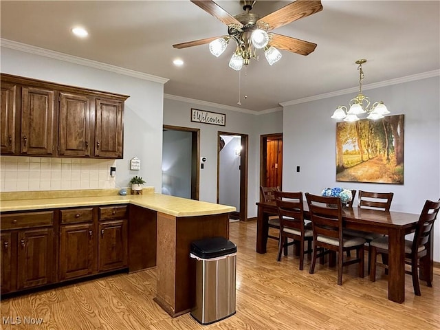 42096 Cadiz Dennison Rd, Cadiz, OH 43907 - kitchen featuring light wood-style floors, light countertops, a peninsula, backsplash, and a ceiling fan