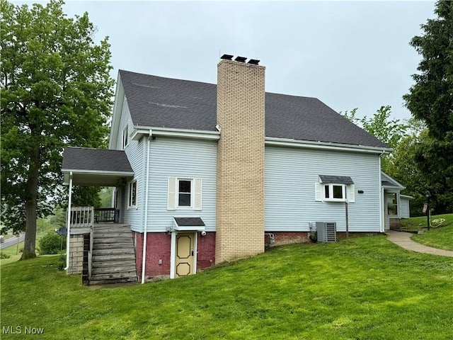 42096 Cadiz Dennison Rd, Cadiz, OH 43907 - rear view of property featuring a chimney, a yard, and stairway
