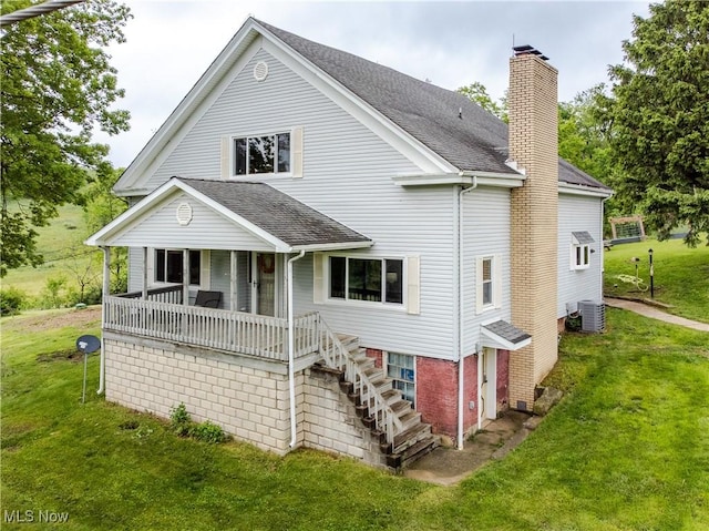 42096 Cadiz Dennison Rd, Cadiz, OH 43907 - rear view of property with cooling unit, a chimney, a yard, and a shingled roof