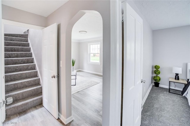 21411 Clare Ave, Maple Heights, OH 44137 - stairs with arched walkways, baseboards, and wood finished floors