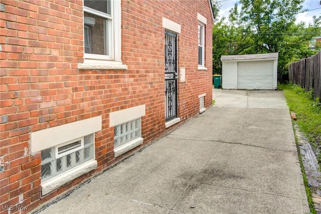 21411 Clare Ave, Maple Heights, OH 44137 - view of side of home featuring brick siding, driveway, and an outdoor structure
