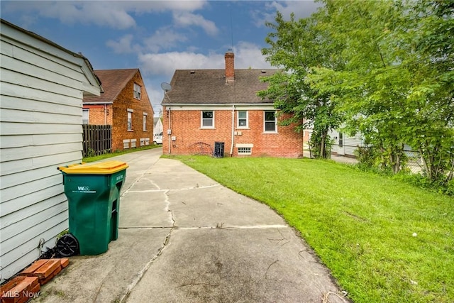 21411 Clare Ave, Maple Heights, OH 44137 - back of house with a chimney, brick siding, and central air condition unit