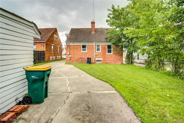 21411 Clare Ave, Maple Heights, OH 44137 - rear view of house with a chimney, brick siding, and central AC unit